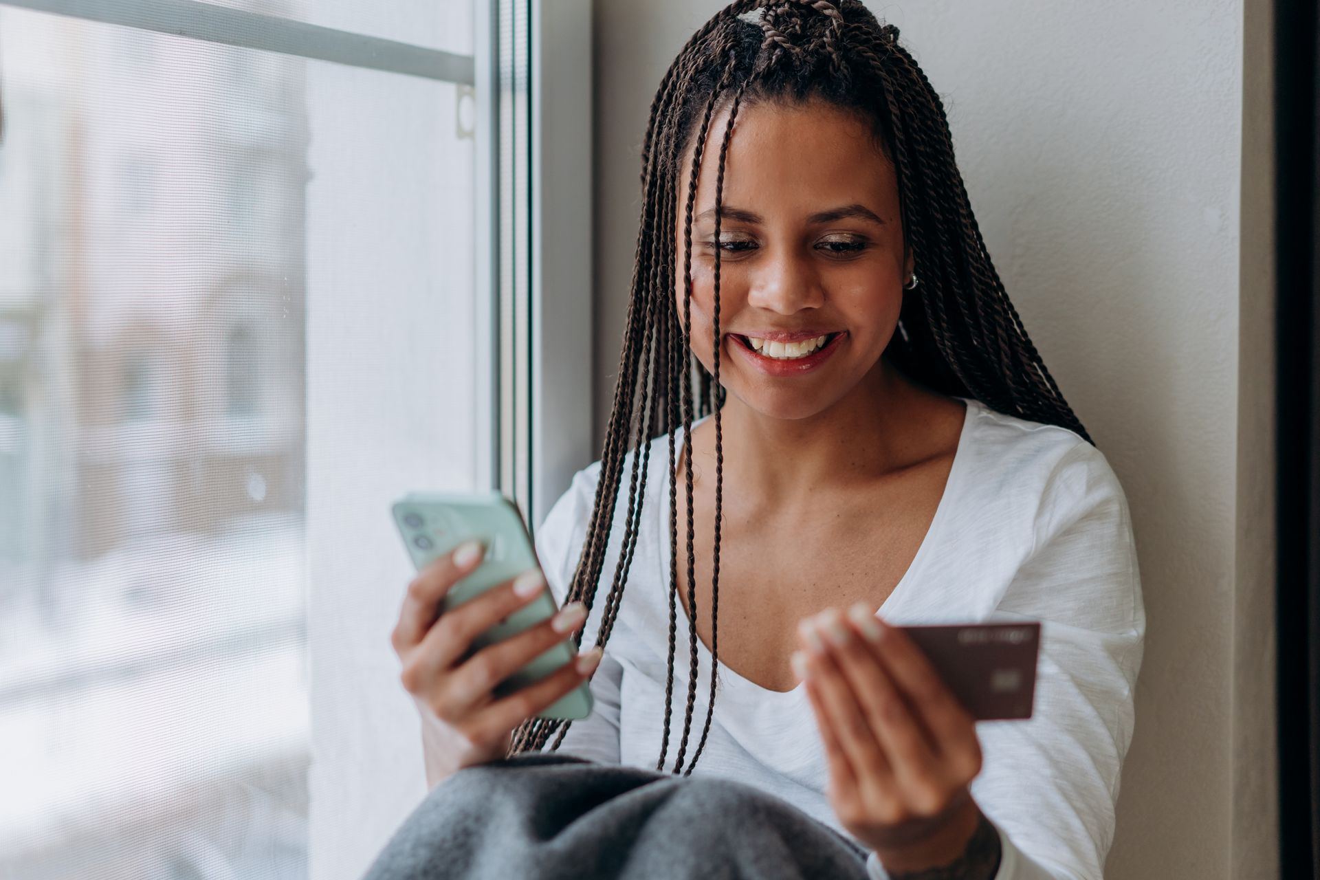 A woman paying with her phone and bank card